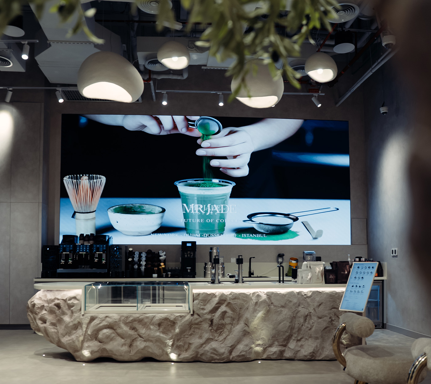 The MRJADE entrance at dusk, awning and warm interior lighting